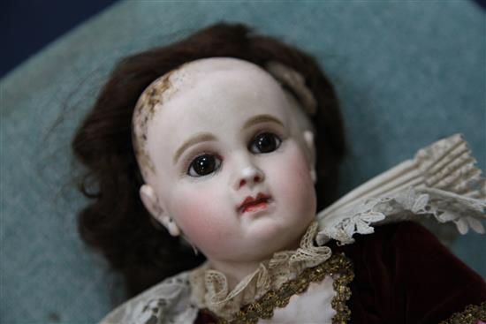 A Jumeau bisque head doll, stamped 7EJ, late 19th century, height 17.5in., small firing crack to right ear